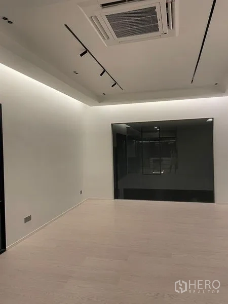 Detached House for sale in Saphan Sung, Bangkok - Minimalist room with concealed LED strip lighting and cassette air-conditioning.