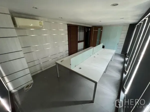 Home Office for rent or sale in Bang Phli, Samut Prakan - Slim office room with long built-in desks and glass partitions.