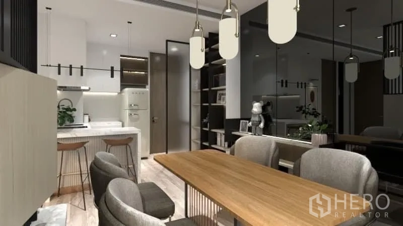 Condominium for rent in Watthana, Bangkok - Dining area looking toward kitchen and entrance with hanging lights.