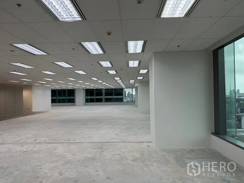 Office Space for rent in Ratchathewi, Bangkok - Long open office zone with rows of LED lights and large windows providing city views.