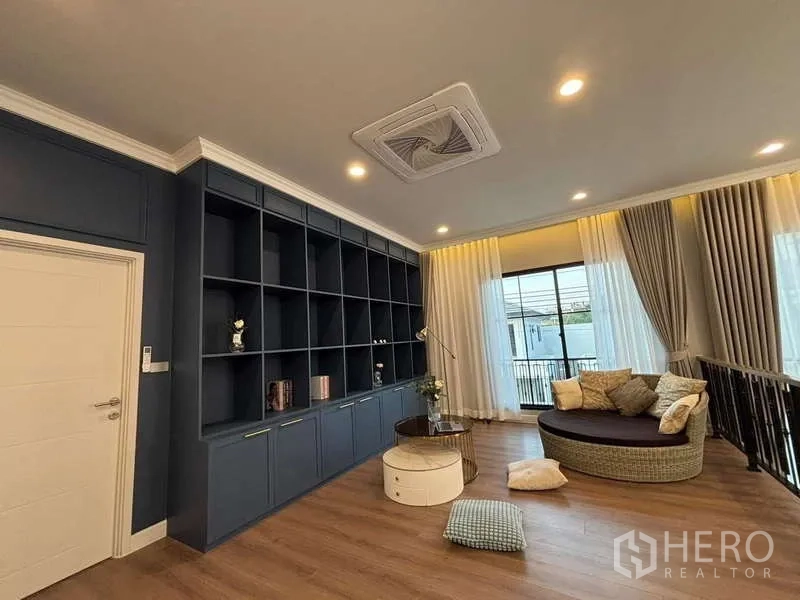 Detached House for rent in Bang Phli, Samut Prakan - Upstairs family lounge with full-height built-in shelving and round daybed by the balcony.
