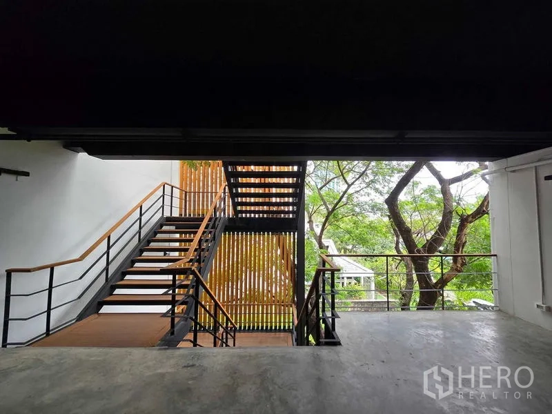 带办公室的家 出租在Chatuchak, Bangkok - 露台视角，可见楼梯与木质屏风，背景为花园。