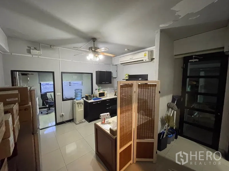 Office Space for rent in Khlong Toei, Bangkok - Pantry area with cabinets, microwave, water dispenser and ceiling fan.