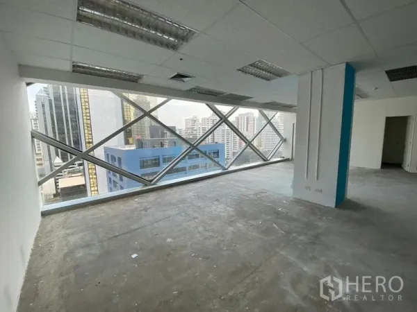 Office Space for rent in Phra Khanong, Bangkok - Bright open-plan office with large diagonal-braced windows and Bangkok skyline views near Asok.