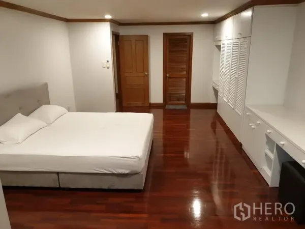 คอนโด ให้เช่าในWatthana, Bangkok - ห้องนอนขนาดใหญ่พร้อมเตียงคู่ ตู้เสื้อผ้าบิลท์อินสีขาว โต๊ะทำงาน และพื้นไม้เงางาม