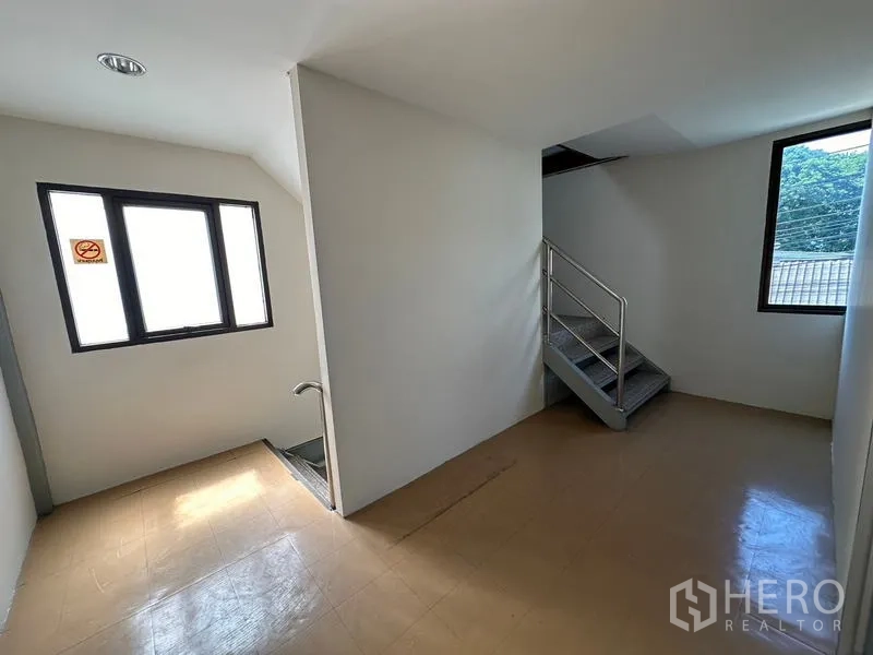 Office Space for rent - Stairwell landing with windows and stainless-steel handrail.