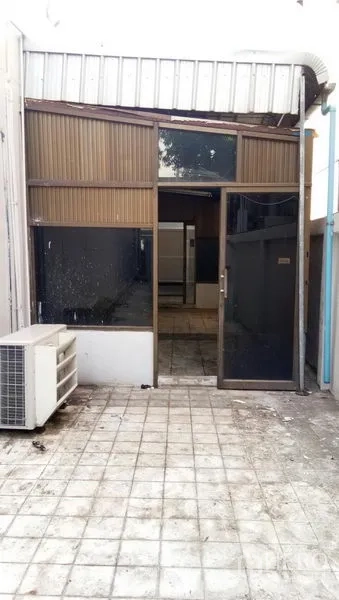 Office Space for rent in Sathon, Bangkok - Rear entrance with tinted glass door and outdoor air-conditioning unit.