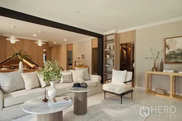 Detached House for sale in Bang Phli, Samut Prakan - Bright lounge with sectional sofa, built-in shelving and accent wall connected to the dining zone.