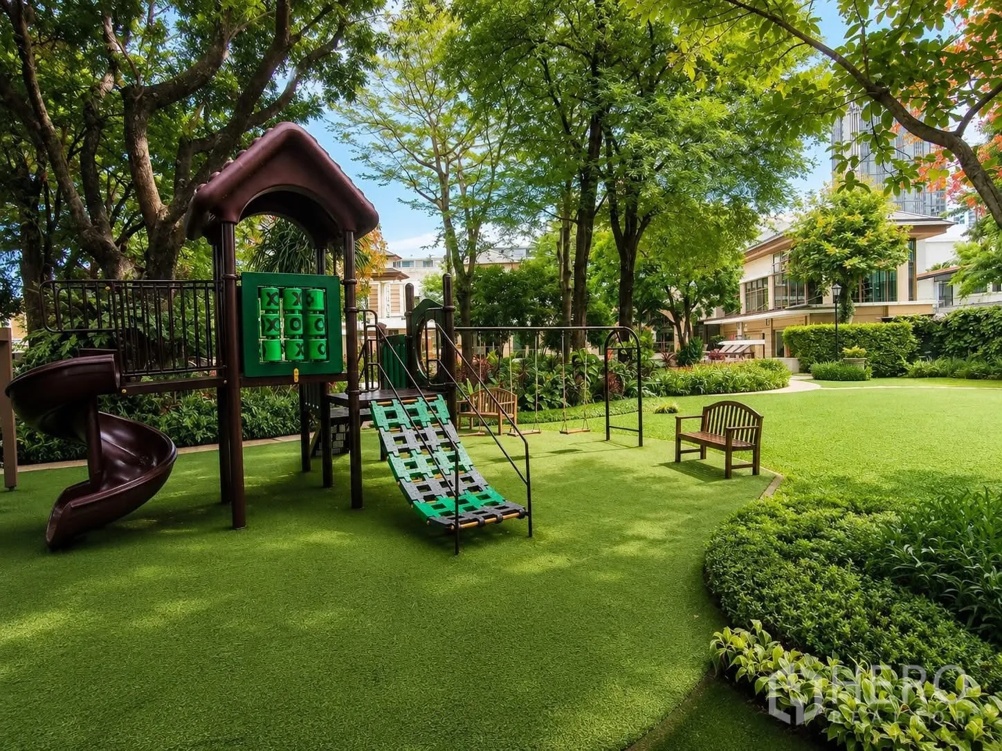 Detached House for rent in Watthana, Bangkok - Shaded playground with slide, swings, benches and manicured lawn in a garden.