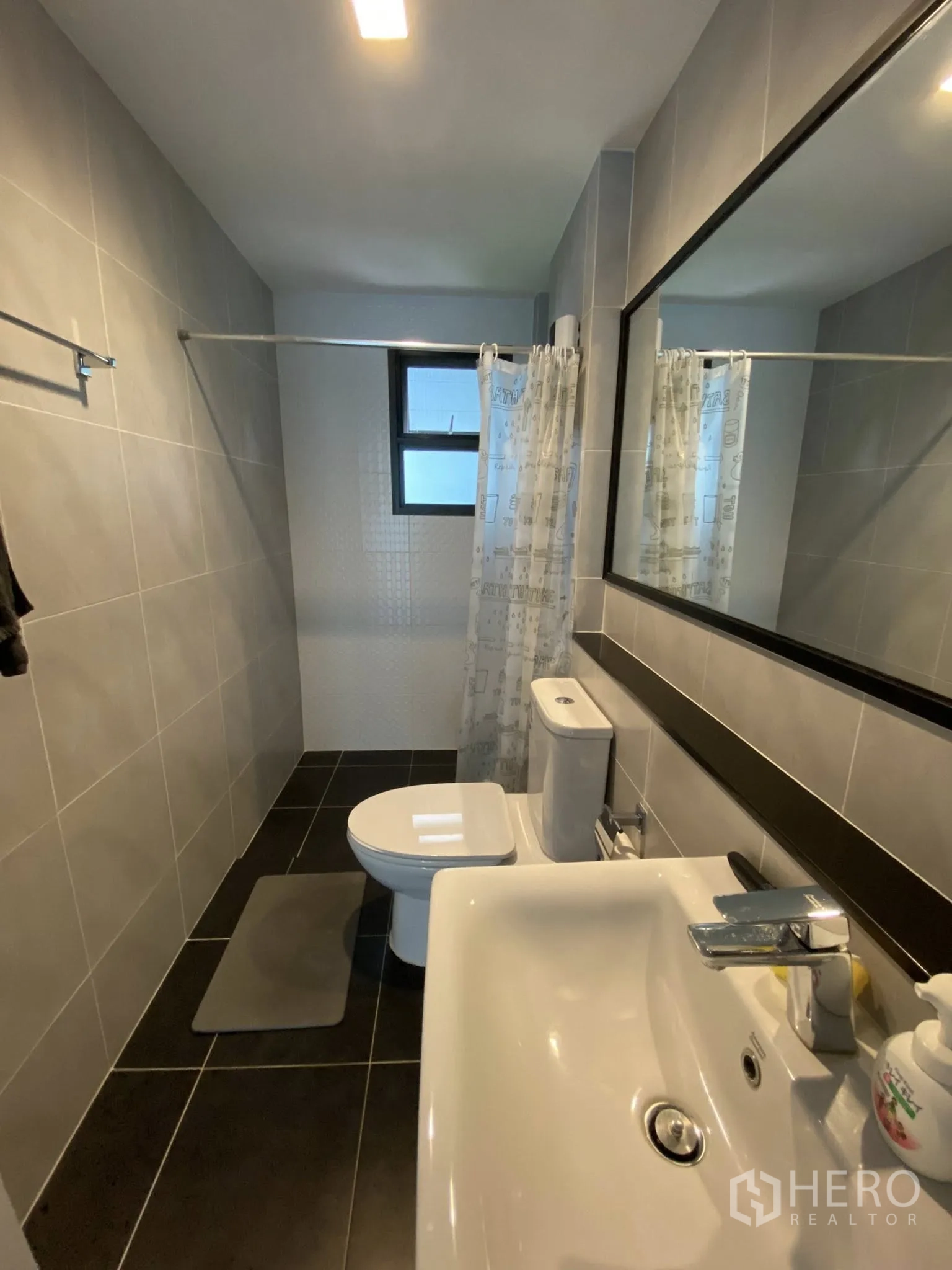 Detached House for sale in Saphan Sung, Bangkok - Modern bathroom with walk-in shower, toilet, and wide mirror.