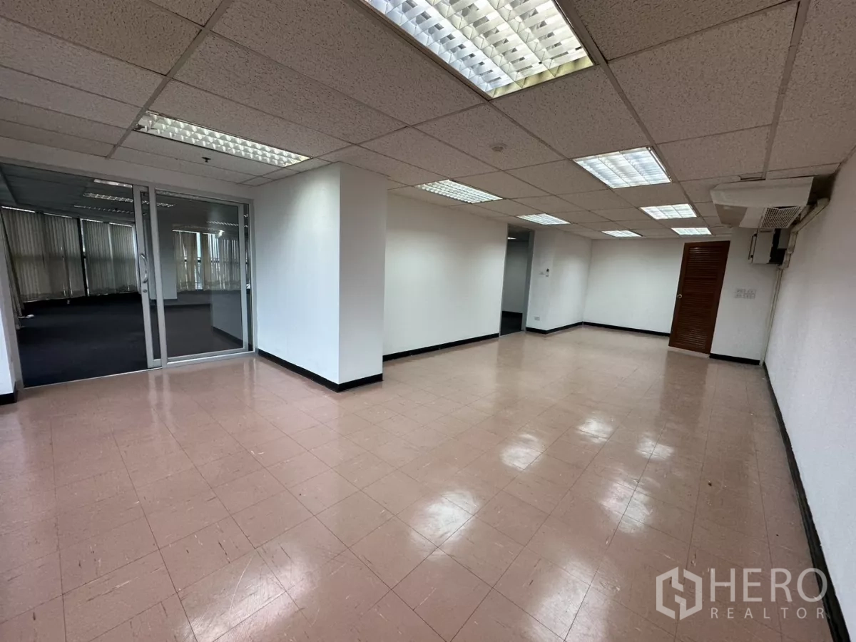 办公空间 出租在Watthana, Bangkok - 瓷砖地房间，适合接待或储物，日光灯照明，墙挂式空调与玻璃入口。