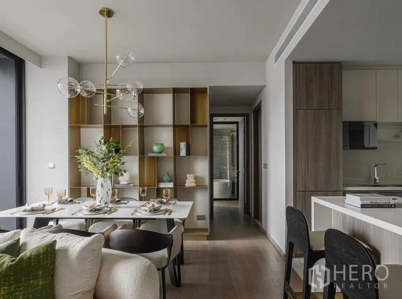 Condominium for rent - Dining zone with modern chandelier, feature shelving and corridor view to the bathroom.