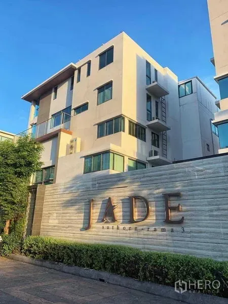 Townhouse for rent or sale in Yan Nawa, Bangkok - Entrance sign for JADE Sathorn–Rama 3 residential project with landscaping.
