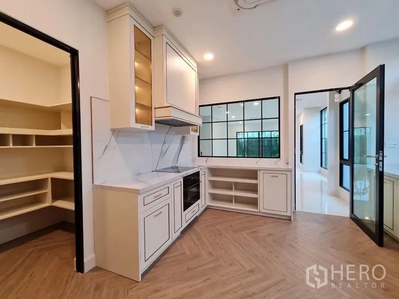 Detached House for rent or sale in Saphan Sung, Bangkok - Kitchen angle showing pantry room, built-in oven and bright countertops.