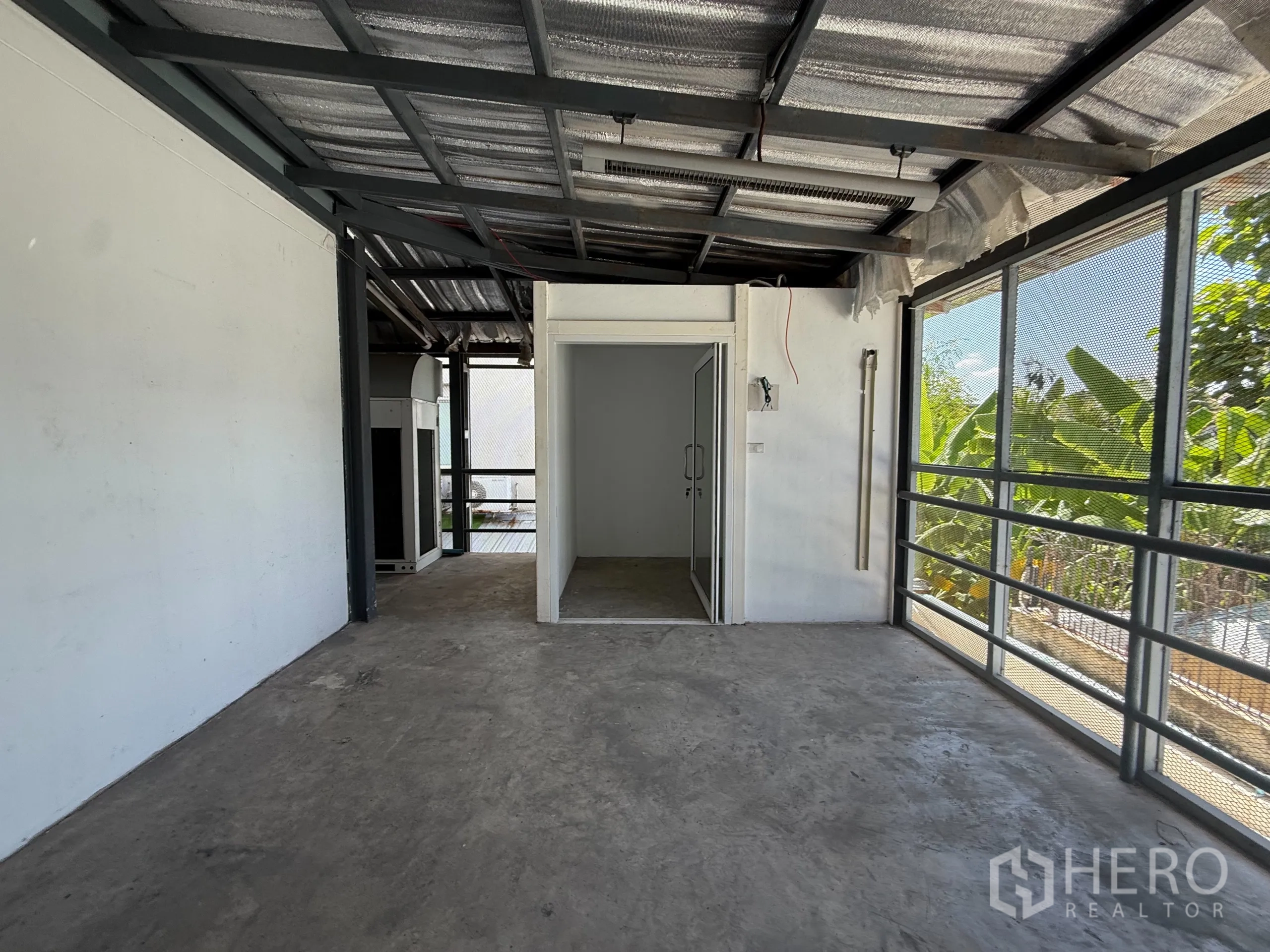 Office Space for rent in Bueng Kum, Bangkok - Street-level view of the office building facade and parking bays.