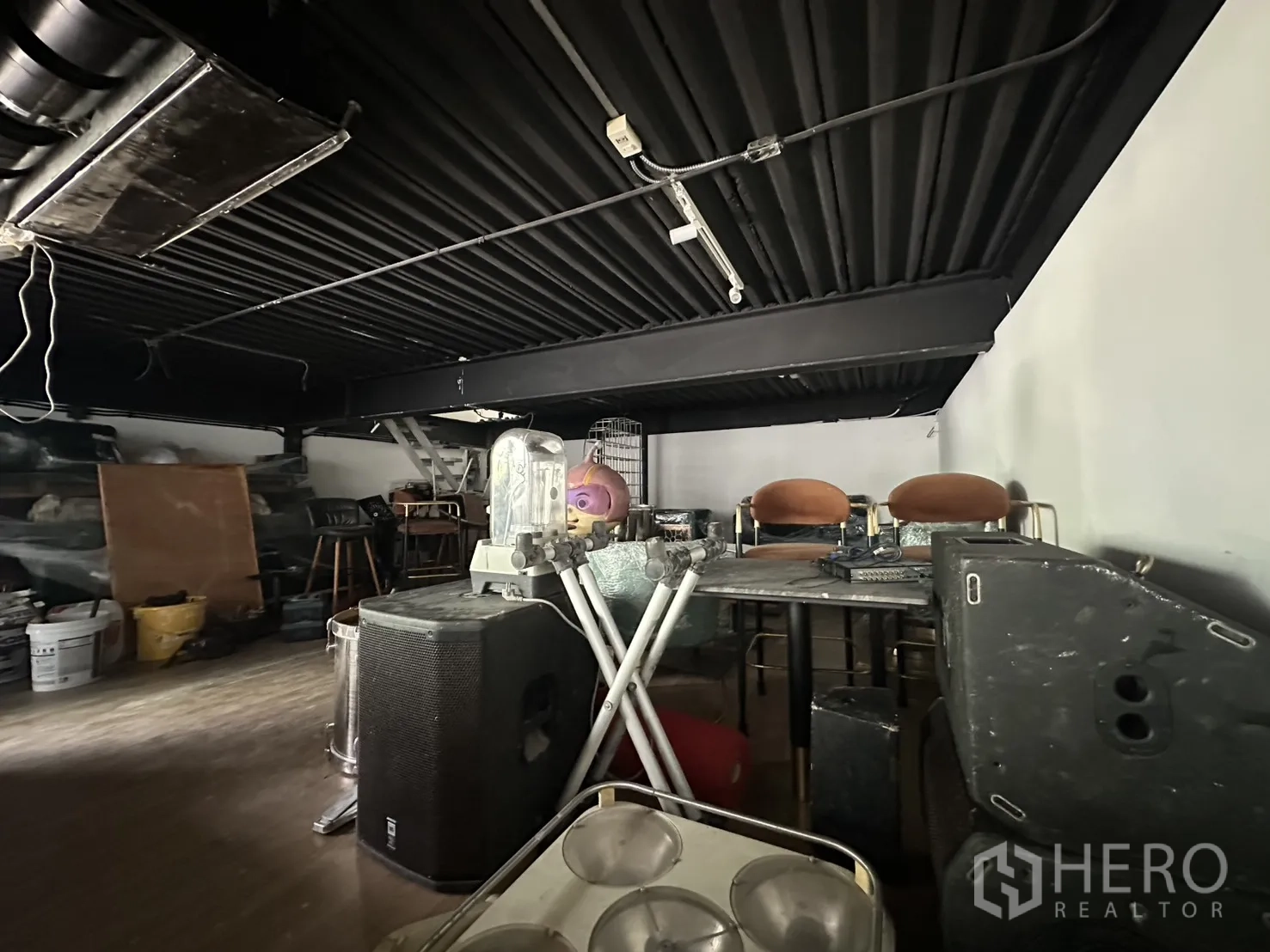 Retail Space for rent in Watthana, Bangkok - Mezzanine level with black ceiling beams and assorted furniture in storage.