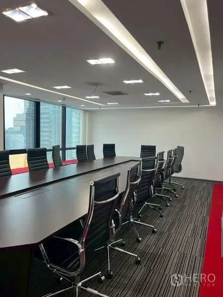 Office Space for rent - Large conference room with a long table, executive chairs, and city views through wide windows.