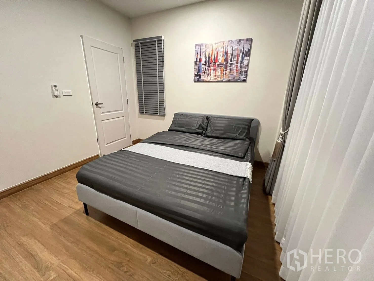 บ้านเดี่ยว for rent in Prawet, Bangkok - มุมห้องนอนแขกเห็นเตียง ประตู หน้าต่างพร้อมบังตา และผ้าม่านทิ้งตัว.