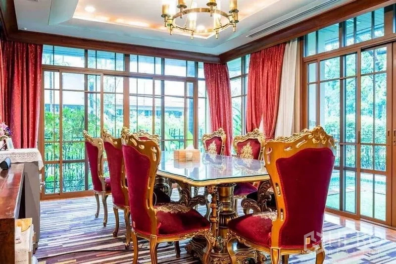 Detached House for sale - Formal dining room with chandelier, ornate chairs and glass walls to garden.