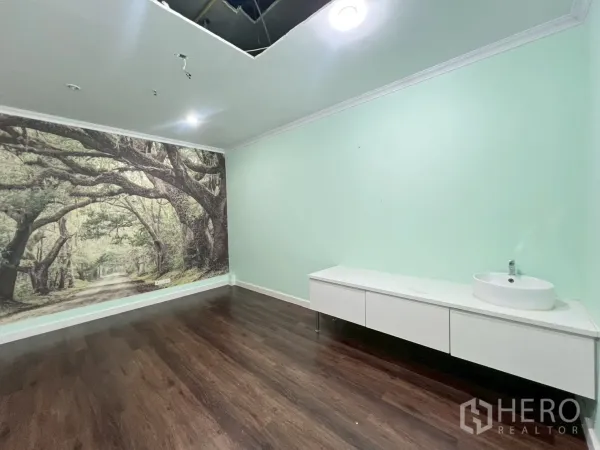 Office Space for rent in Watthana, Bangkok - Wide view of room featuring a forest mural, spotlights and ceiling access panel over wood flooring.