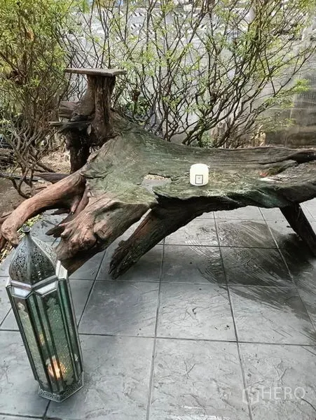 Detached House for rent in Ratchathewi, Bangkok - Rustic driftwood bench and lantern on a tiled terrace.