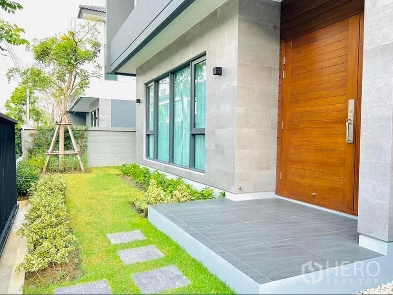 Detached House for rent in Bang Phli, Samut Prakan - Front entry with wooden door, terrace and landscaped garden.