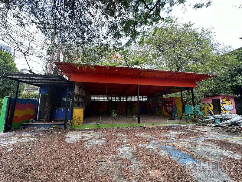 Detached House for rent in Watthana, Bangkok - Open-sided pavilion with a red metal roof and painted walls in the yard.