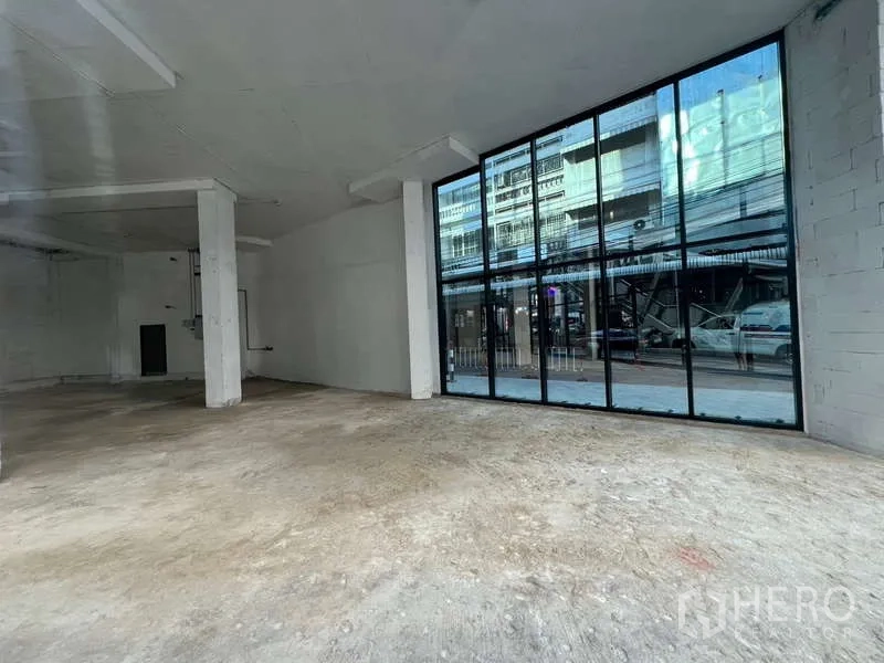 Retail Space for rent in Khlong Toei, Bangkok - Street-facing storefront with black-framed glass panels offering prominent signage.