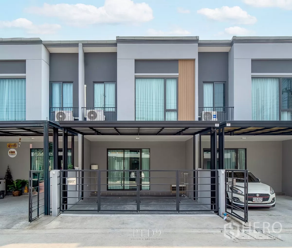 Townhouse for rent in Bang Phli, Samut Prakan - Modern two‑storey townhouse exterior with double covered carport and metal gate