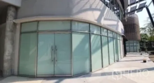 零售空间 出租在Khlong Toei, Bangkok - 街层转角商铺，环绕玻璃立面与双入口大门。