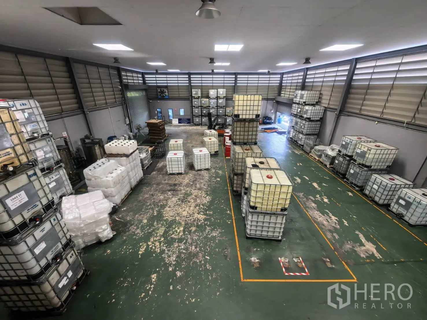Warehouse for rent in Bang Sao Thong, Samut Prakan - Mezzanine view of storage area with marked zones and roller access.