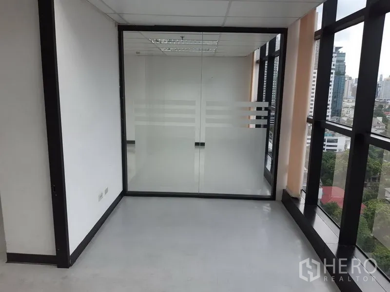 Office Space for rent in Watthana, Bangkok - Small glass-enclosed room beside panoramic windows with city views.