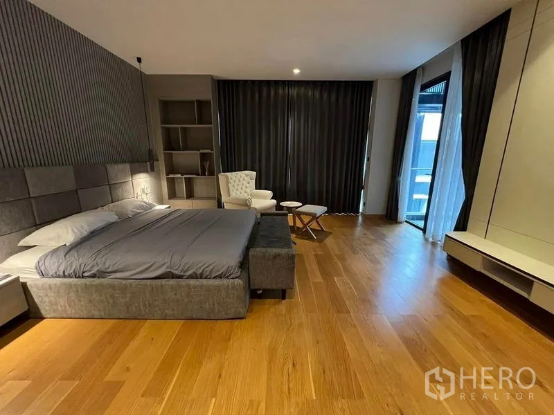Detached House for sale in Suan Luang, Bangkok - Master bedroom view showing large windows, dark curtains and timber flooring.