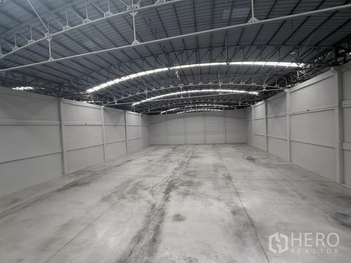 工厂 出租在Bang Phli, Samut Prakan - 大型无柱仓库，高挑拱形钢结构屋顶与混凝土地面。