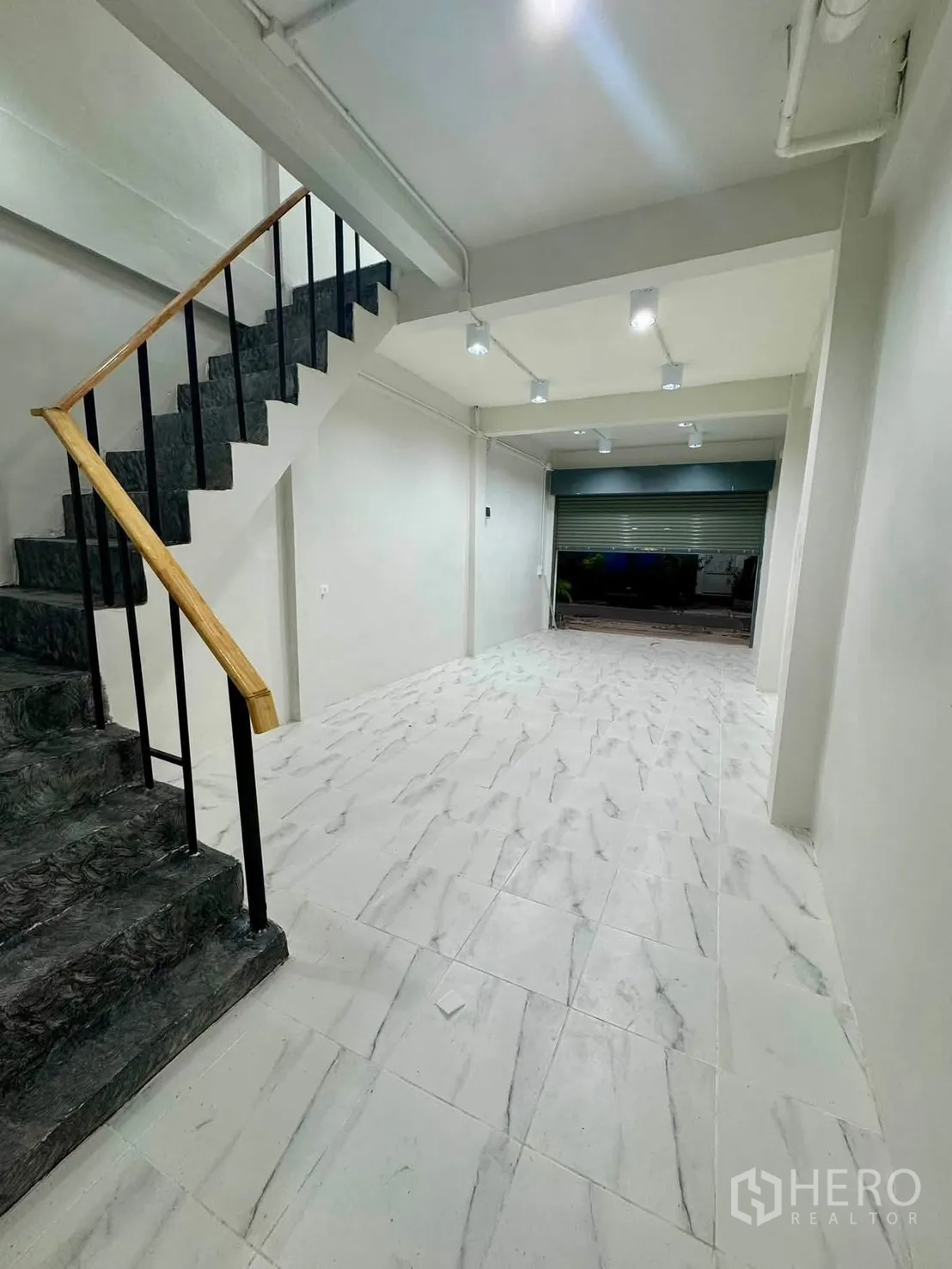 Shophouse for rent in Sathon, Bangkok - Long open workspace with ceiling spotlights and tiled floor.