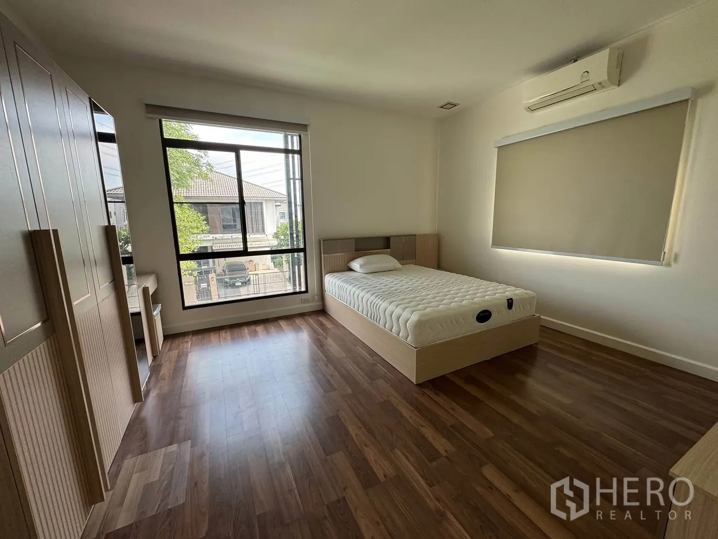 บ้านเดี่ยว for rent in Prawet, Bangkok - ห้องนอนกว้างมีเตียง ชุดตู้เสื้อผ้า โต๊ะเครื่องแป้ง พื้นไม้ และหน้าต่างบานใหญ่