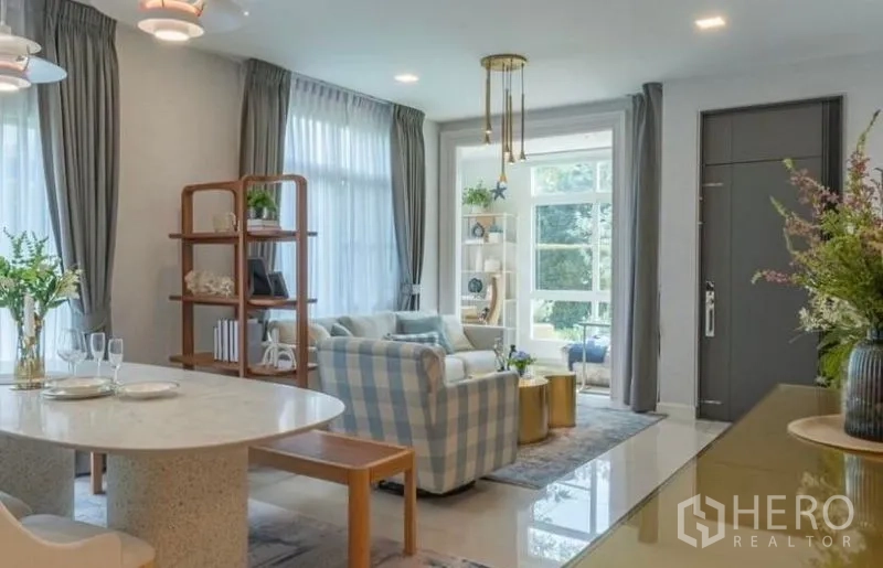 Detached House for rent in Bang Phli, Samut Prakan - Open-plan living and dining room with large windows and soft drapery.