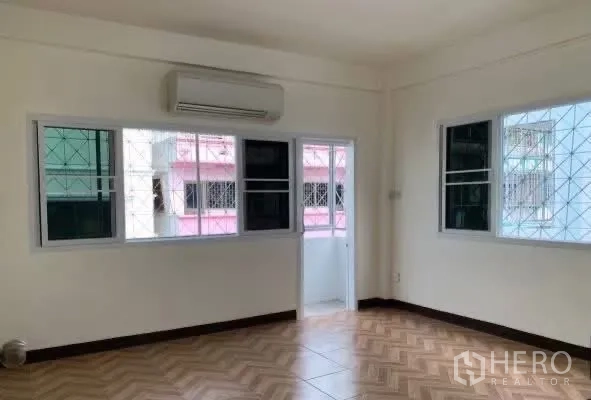 Home Office for rent in Sathon, Bangkok - Air-conditioned room with multiple windows and balcony access.