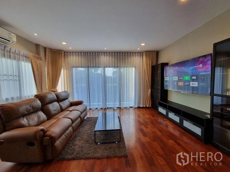 Detached House for rent in Bang Khae, Bangkok - Bright media lounge with recliner sofa and wide-screen TV.