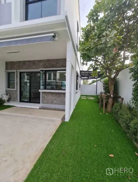 ทาวน์เฮาส์ ให้เช่าในBang Phli, Samut Prakan - ด้านข้างตัวบ้าน สนามหญ้า ต้นไม้ใหญ่ และทางเดินมีหลังคา