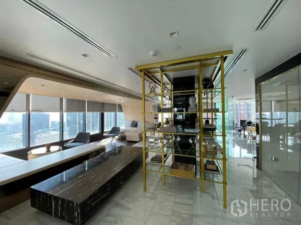 Condominium for rent or sale in Ratchathewi, Bangkok - Sky lounge with marble floors and gold shelving overlooking the Bangkok skyline.