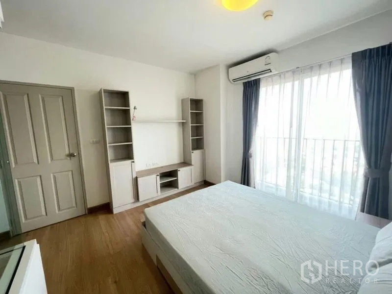 Condominium for sale - Second bedroom with built-in storage, air conditioner and balcony window.