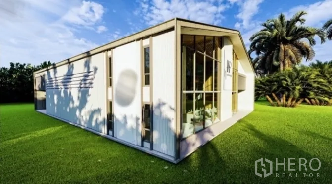 货栈 出租在Samut Prakan - 仓库侧立面，竖向金属板外墙，坐落在绿草地与棕榈树旁。