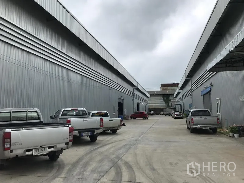 货栈 出租在Bang Phli, Samut Prakan - 两排仓库相对而立，中间通道可停车并设装卸区。