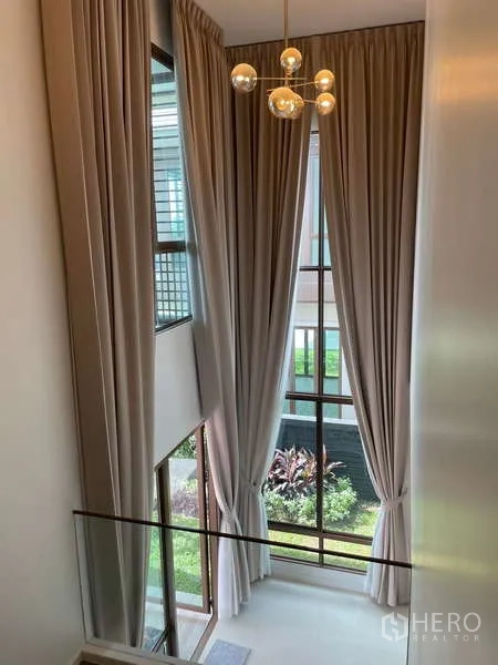 Detached House for rent in Bang Kapi, Bangkok - Double-height foyer with floor-to-ceiling drapes and garden outlook.