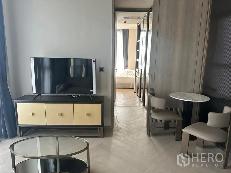 Condominium for rent - TV console and round dining table beside the doorway to the bedroom.