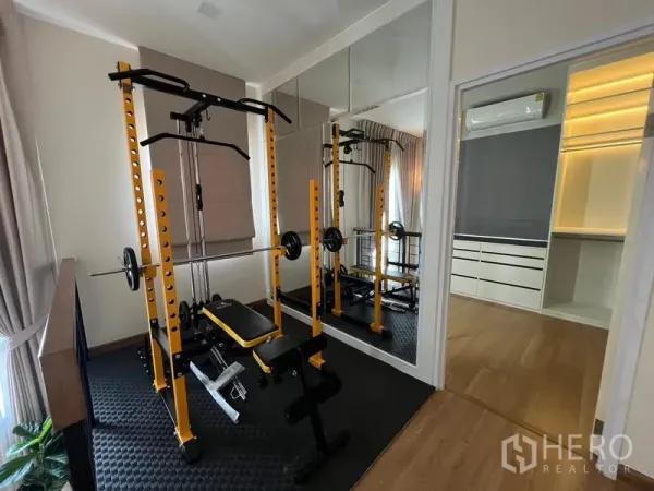 Detached House for rent or sale - Home gym room with weight rack, mirrors and access to a dressing area.