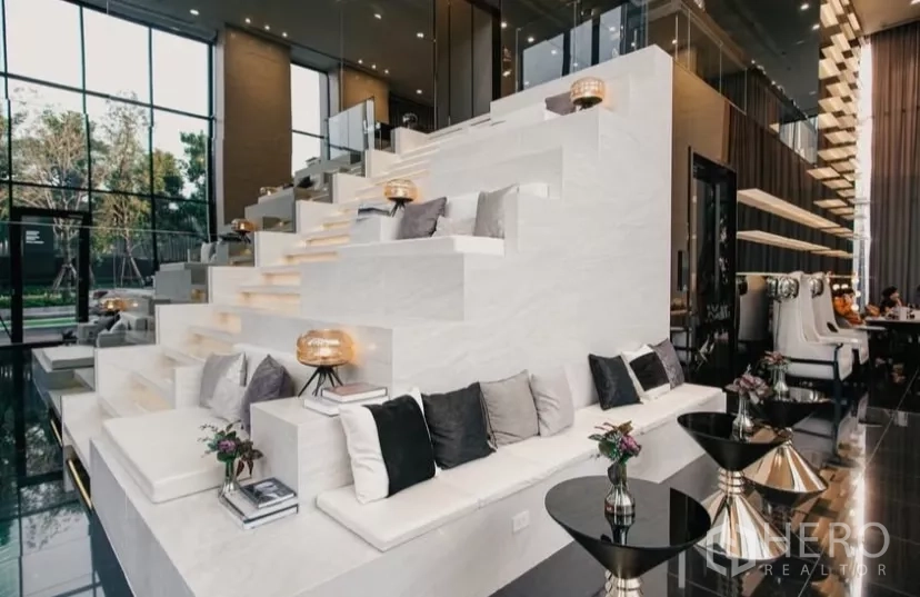 Condominium for rent in Chatuchak, Bangkok - Grand lobby with tiered seating, high ceilings, and modern decor.