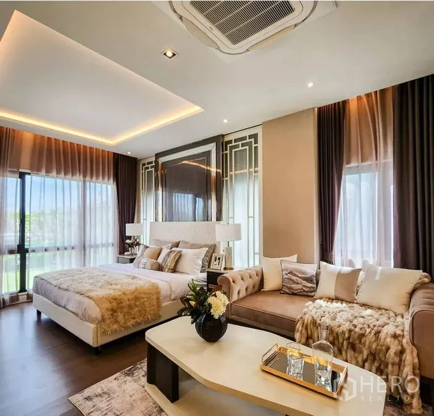 Detached House for sale in Bang Phli, Samut Prakan - Spacious primary suite with seating area, large windows and warm accent lighting.