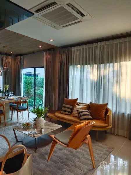 Detached House for rent in Bang Phli, Samut Prakan - Open-plan living area with sofa, large windows and garden outlook.